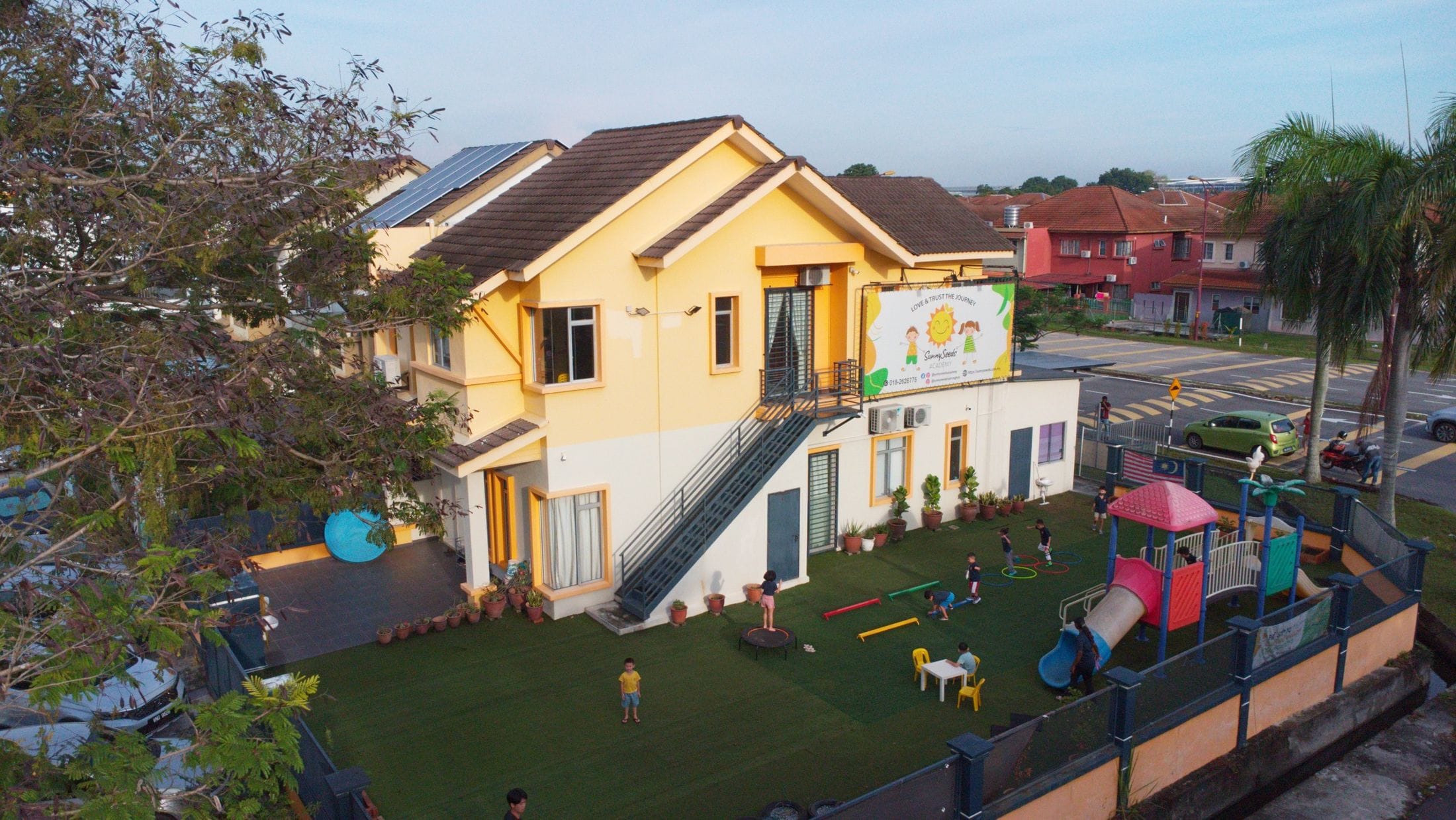 The SunnySeeds Academy building in Aman Perdana, Klang, with its garden playground at sunrise