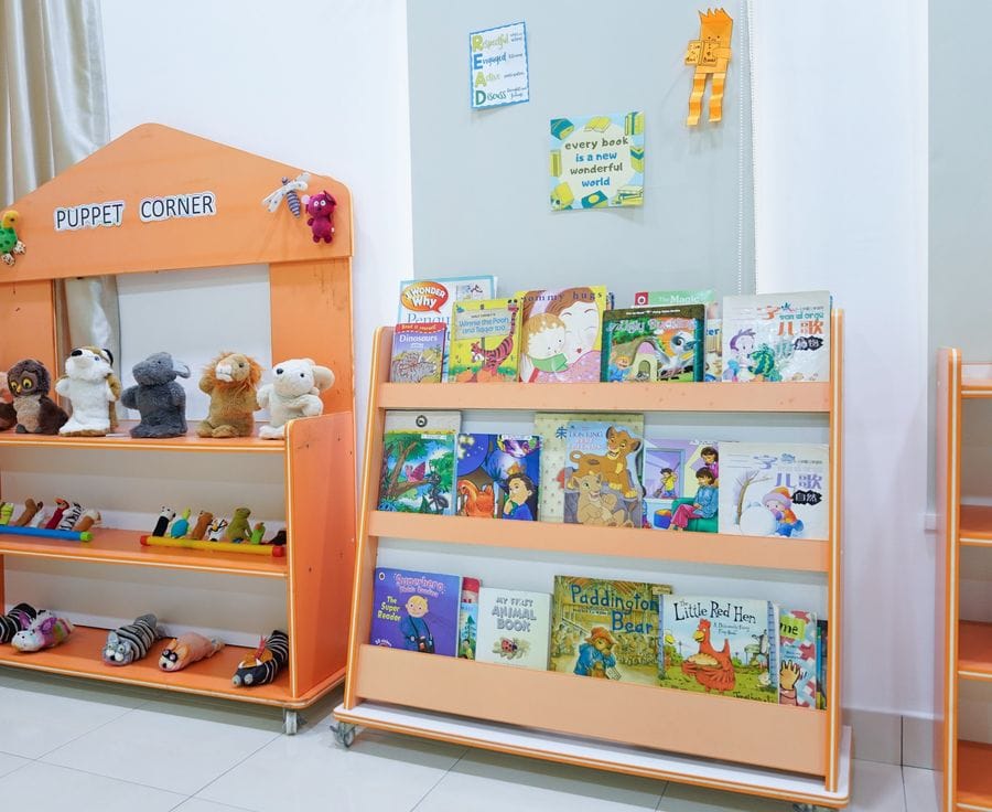 The puppet corner and book shelf in a SunnySeeds classroom