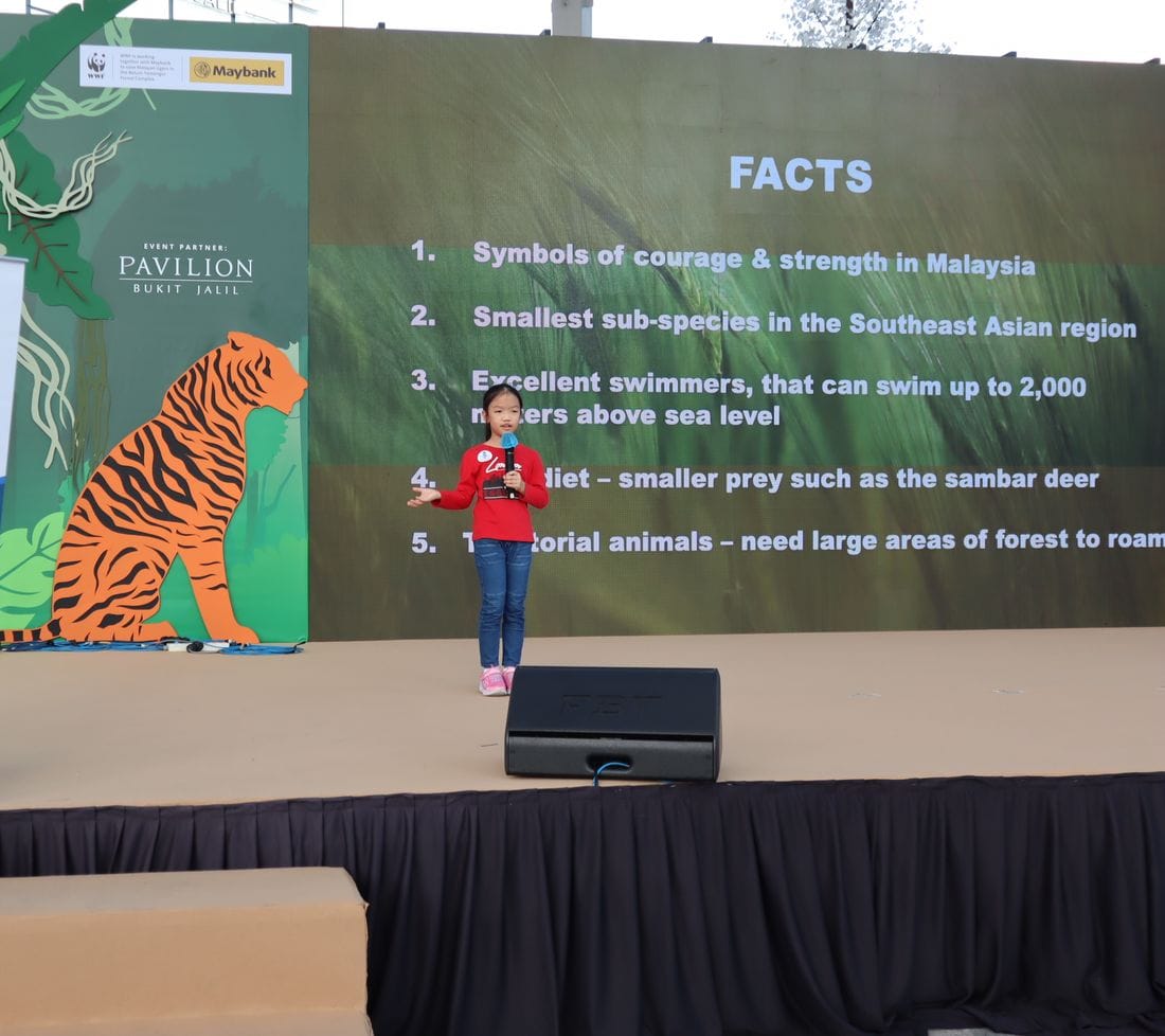 A young speaker presenting on a stage